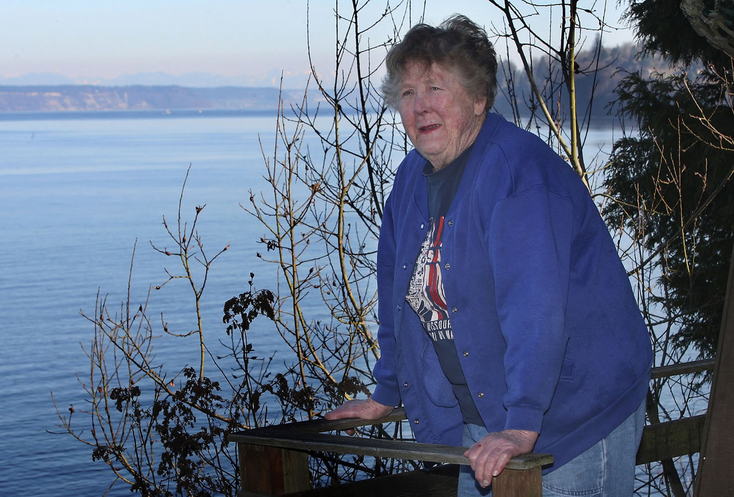 Adele Ferguson looks out from her deck in Hansville in March 2009. Ferguson, a pioneering female journalist and a longtime reporter and columnist for the Bremerton Sun, died Monday.