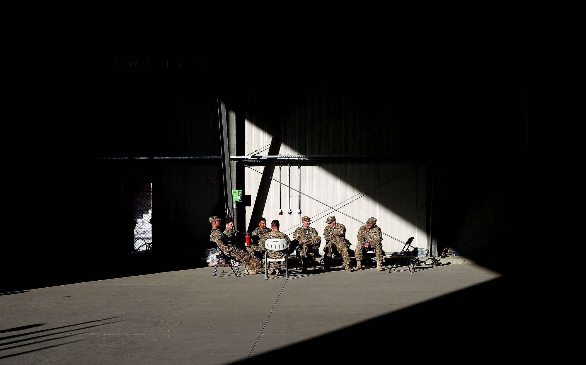 International Security Assistance Forces soldiers rest before a flag-lowering ceremony in Kabul, Afghanistan, on Monday. The U.S. and NATO ceremonially ended their combat mission in Afghanistan on Monday, 13 years after the Sept.