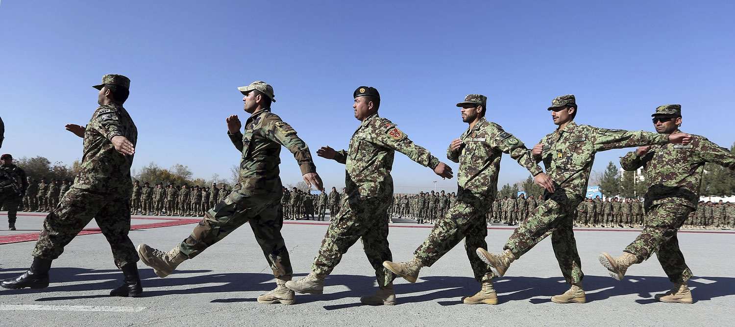 New members of the Afghan National Army march Sunday during their graduation ceremony at the Afghan Military Academy in Kabul, Afghanistan. Afghanistan's parliament approved agreements Sunday with the U.S.