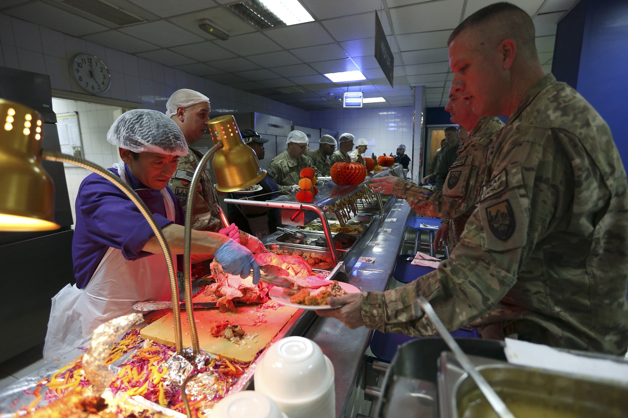 NATO soldiers line up to get Thanksgiving Day meals Thursday at the ISAF headquarters in Kabul, Afghanistan.
