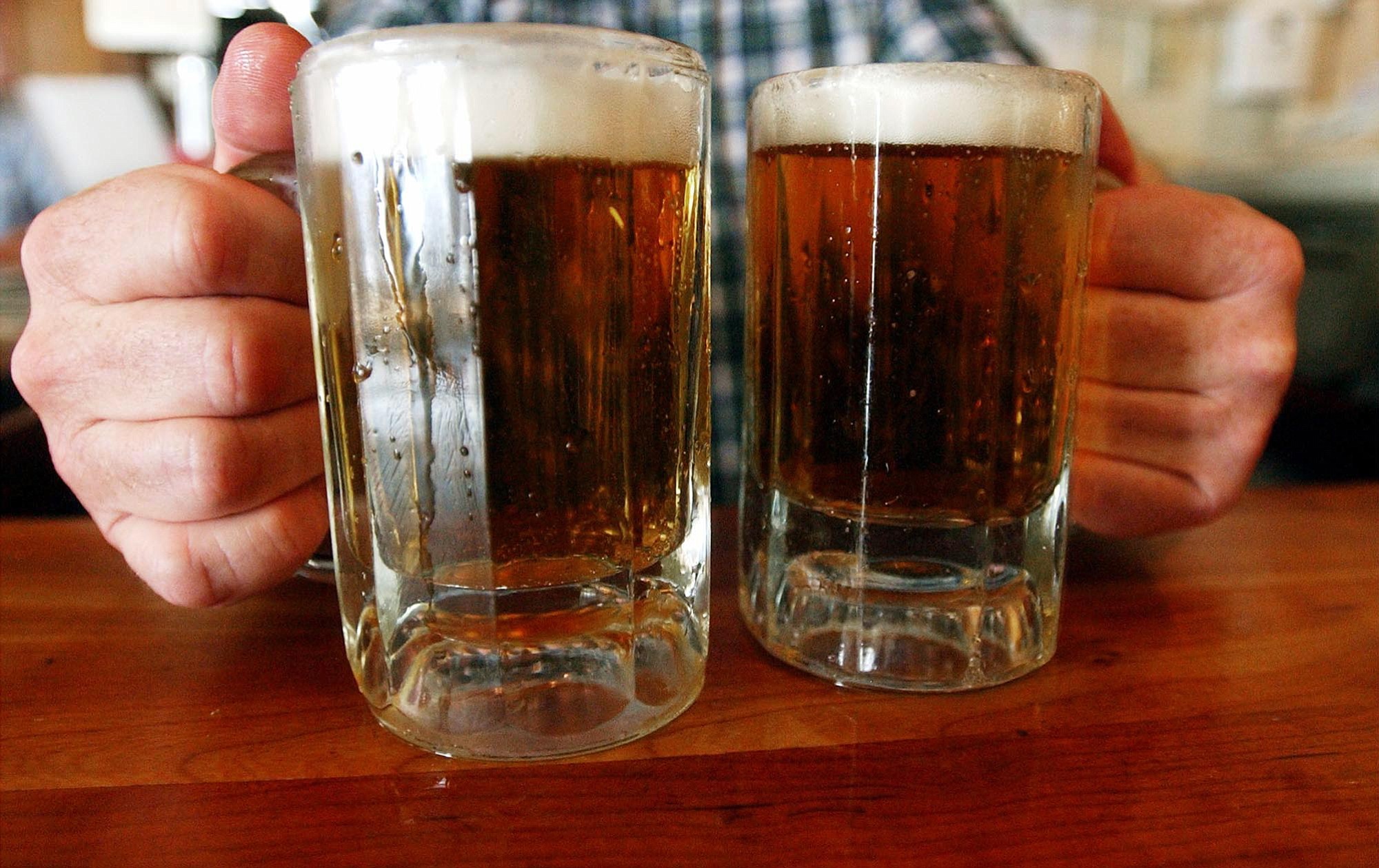 A bartender serves two mugs of beer at a tavern in Montpelier, Vt. Alcohol problems affect almost 33 million adults and most have never sought treatment.