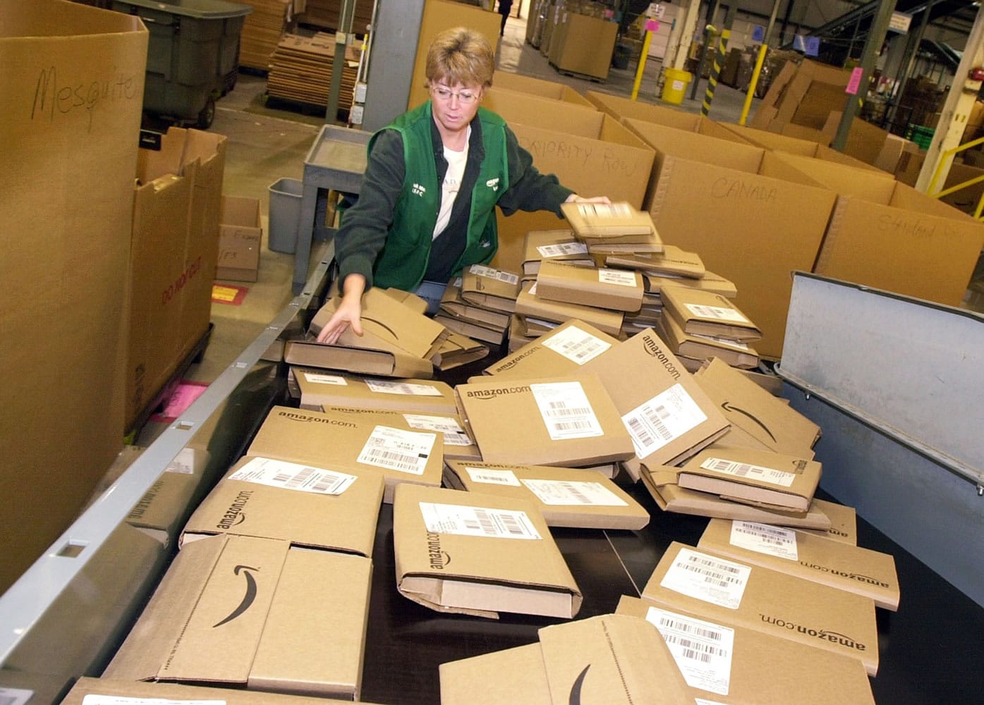 An Amazon employee sorts through orders ready to be shipped from its Coffeyville, Kan., warehouse in 2002.