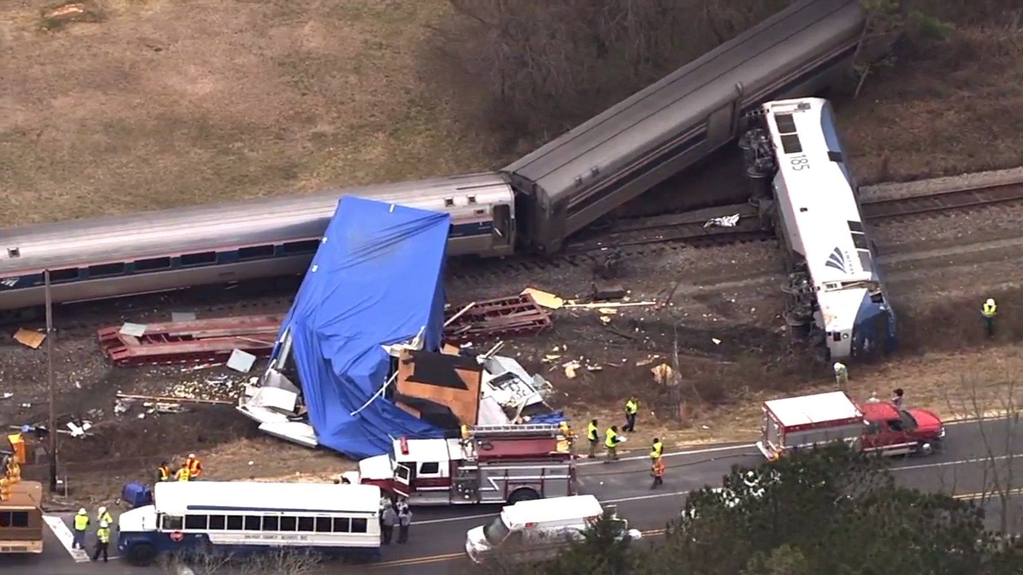 In this frame grab from video provided by WTVD-11, authorities respond to a collision between an Amtrak passenger train and a truck Monday in Halifax County, N.C.
