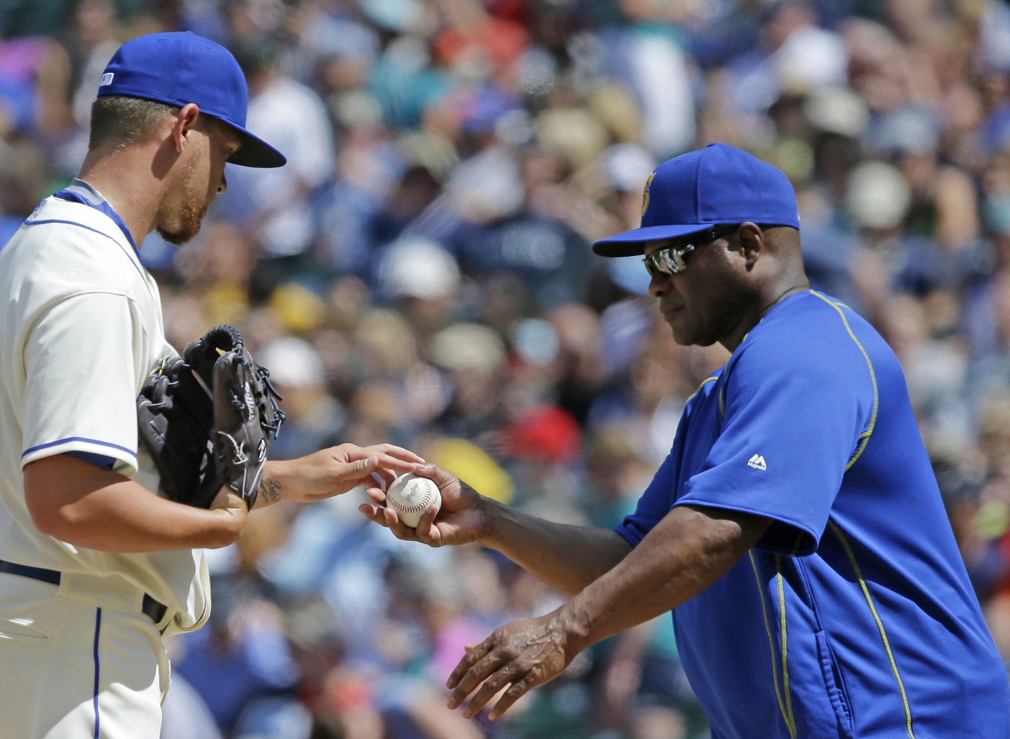 Seattle Mariners pitcher David Rollins, left, is pulled by manager Lloyd McClendon, right, in the sixth inning against the Los Angeles Angels, Sunday, July 12, 2015, in Seattle. (AP Photo/Ted S.