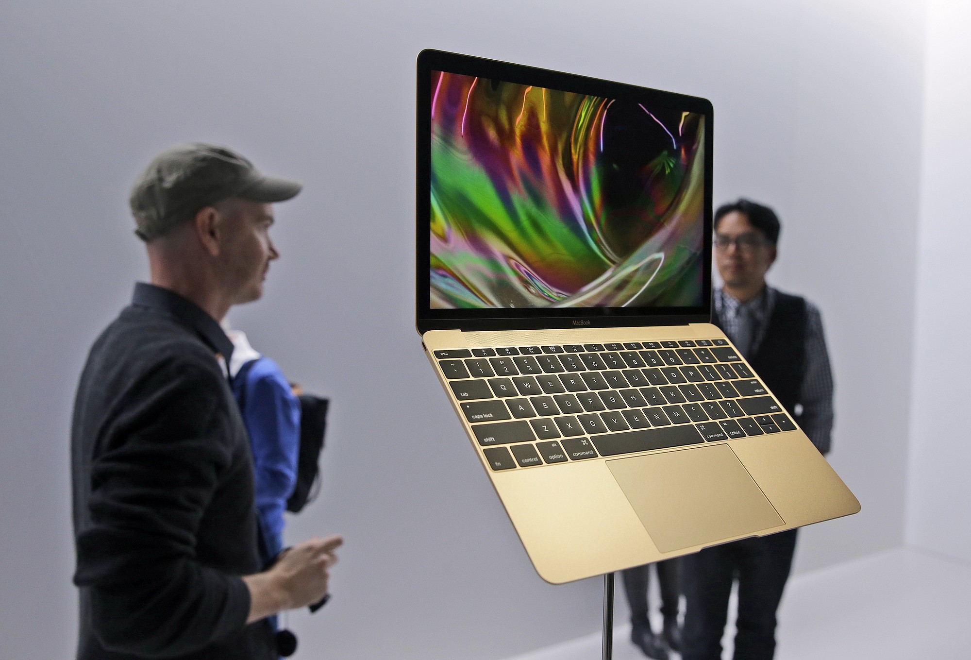 Members of the media and Apple guests get a look at a display of the new MacBook in the demo room after an Apple event on Monday in San Francisco.