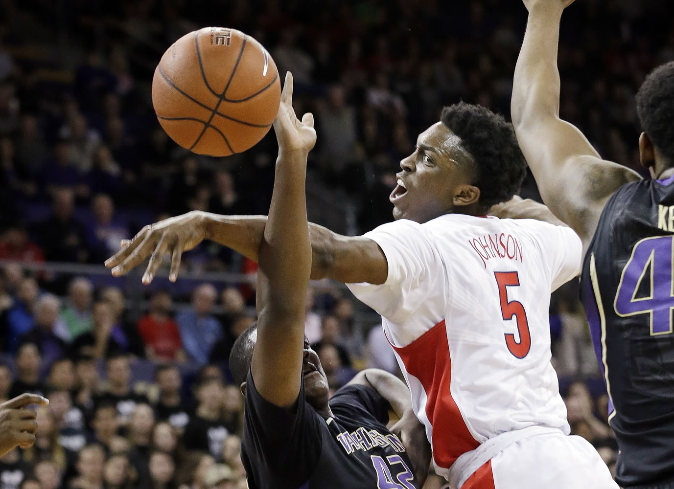 Arizona's Stanley Johnson (5) tries to knock the ball away as Washington's Donaven Dorsey drives during the first half Friday, Feb.