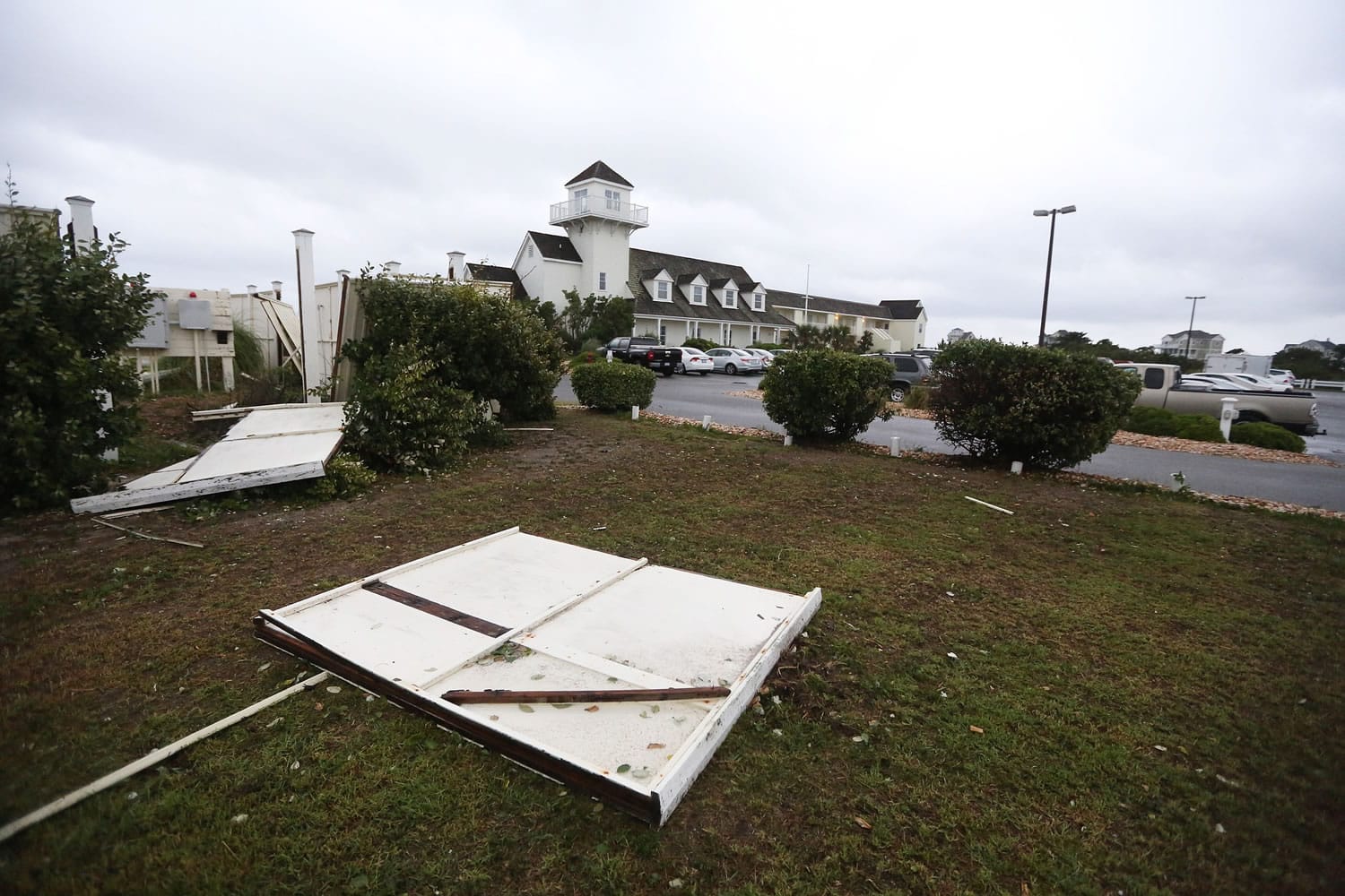Downed signs, fences and a few tree limbs litter the ground in Hatteras Village, N.C., on Friday.