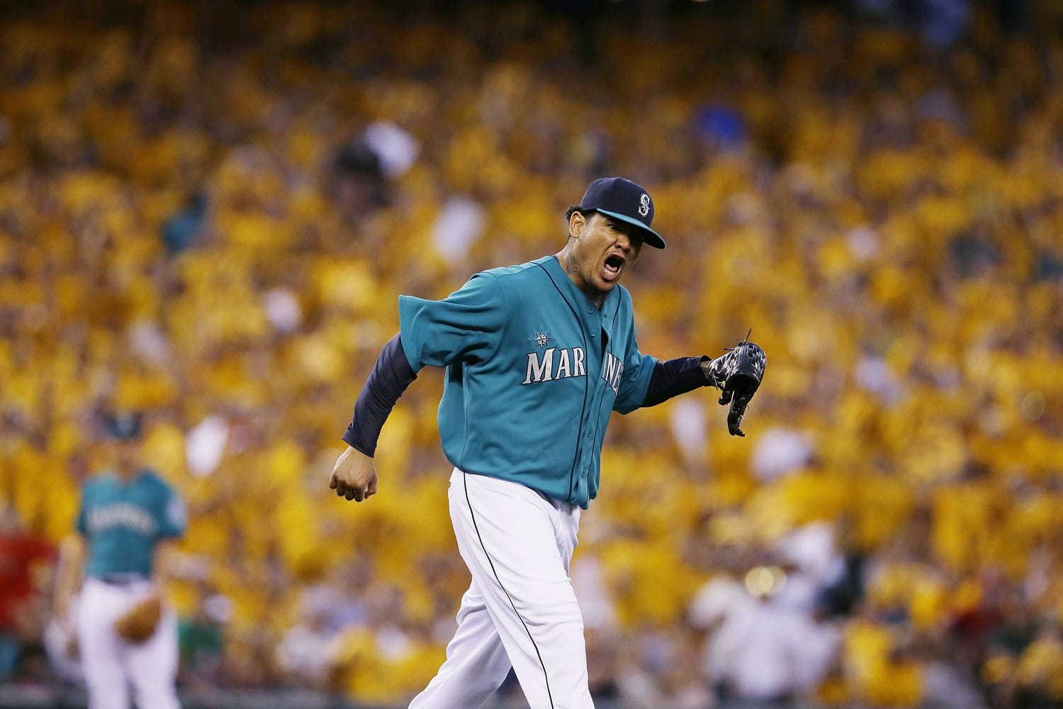 With a sea of yellow from his &quot;King's Court&quot; cheering section behind him, Seattle Mariners starting pitcher Felix Hernandez yells after a double play in the eighth inning of a baseball game against the Oakland Athletics, Friday, July 11, 2014, in Seattle. (AP Photo/Ted S.