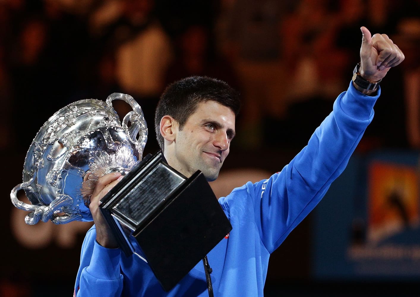 Novak Djokovic holds the champions trophy after defeating Andy Murray in the men's singles final at the Australian Open tennis championship in Melbourne, Australia, Sunday, Feb. 1, 2015.