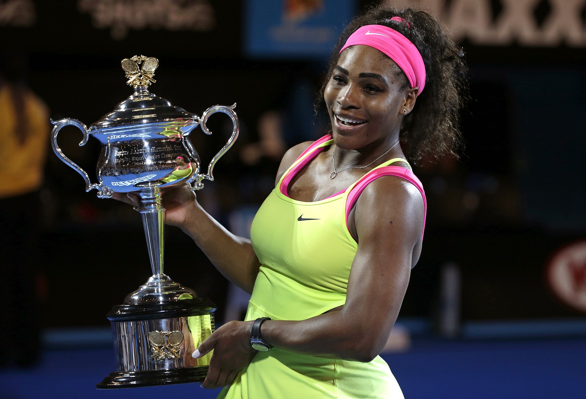 Serena Williams of the U.S. holds the trophy after defeating Maria Sharapova of Russia in the women's singles final at the Australian Open tennis championship in Melbourne, Australia, Saturday, Jan. 31, 2015.