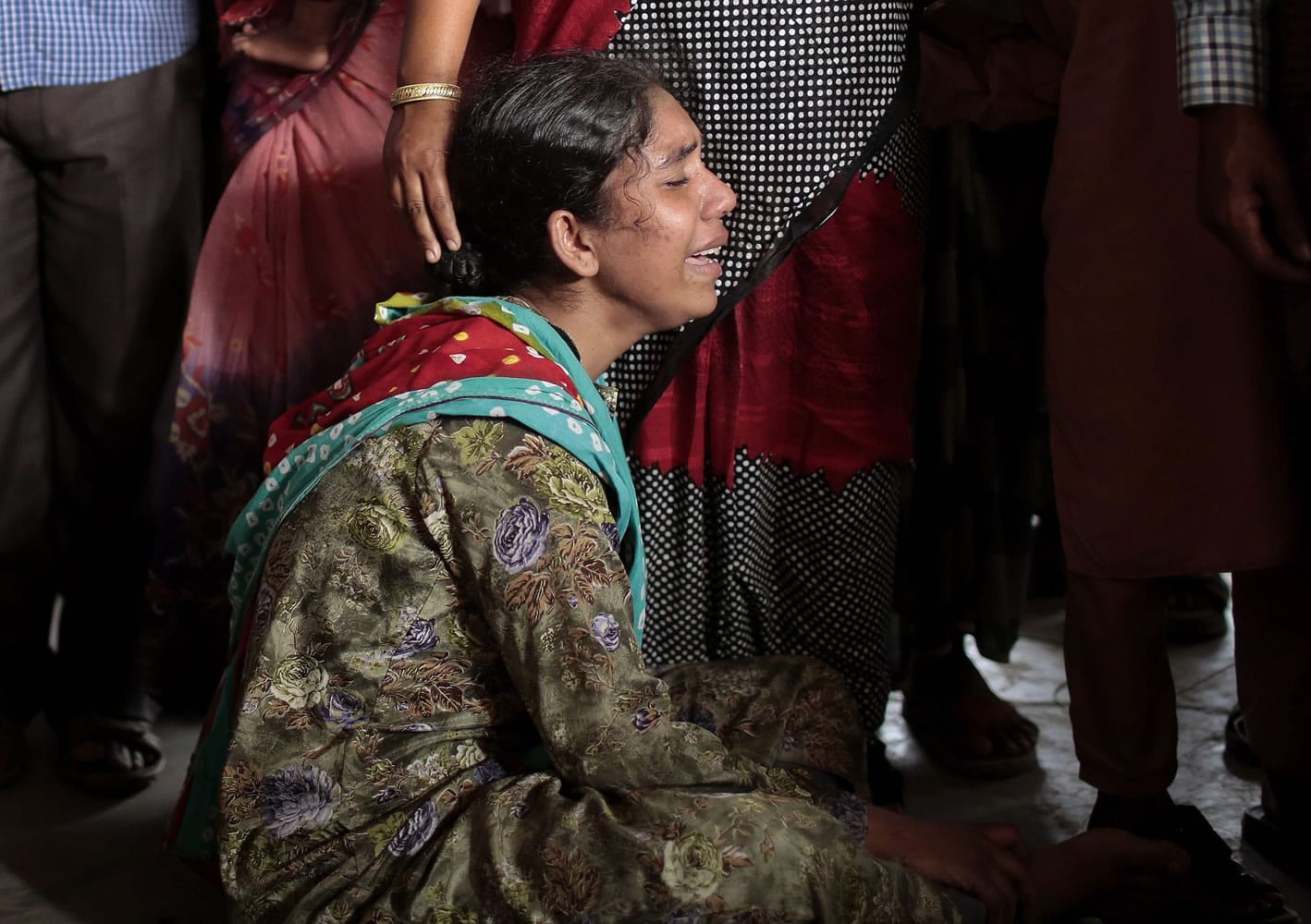 A Bangladeshi woman cries after finding the body of her relative, a victim of a capsized ferry in Manikganj district, about 40 kilometers northwest of Dhaka, Bangladesh, on Monday.