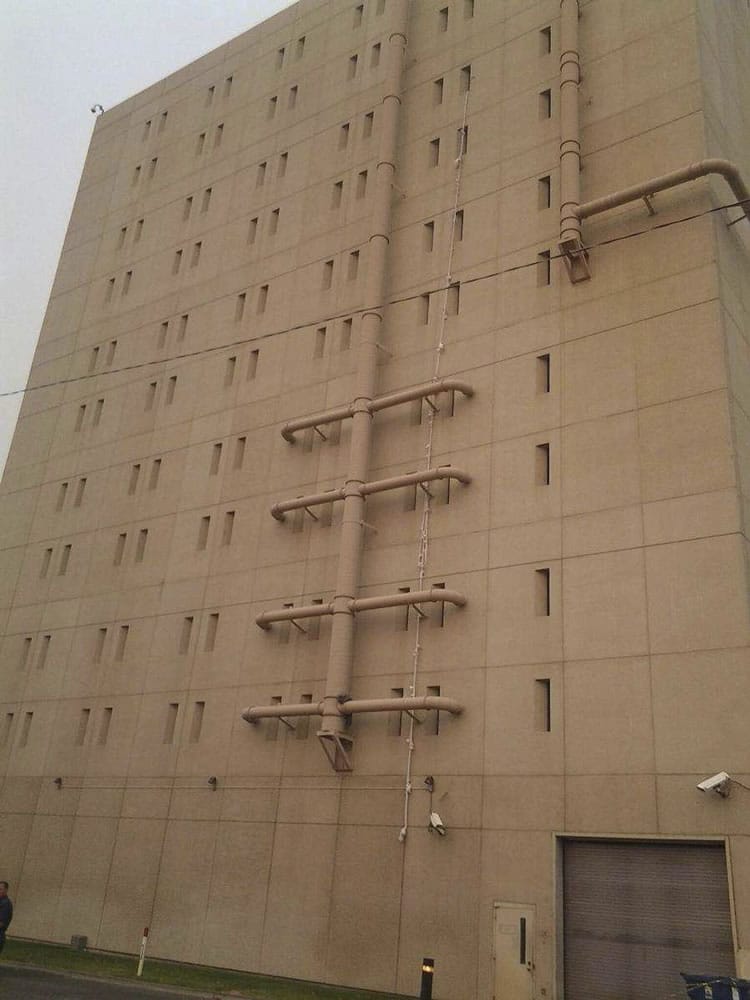 Bed sheets used in an apparent escape attempt hang from a top-floor window of the Spokane County Jail in Spokane.