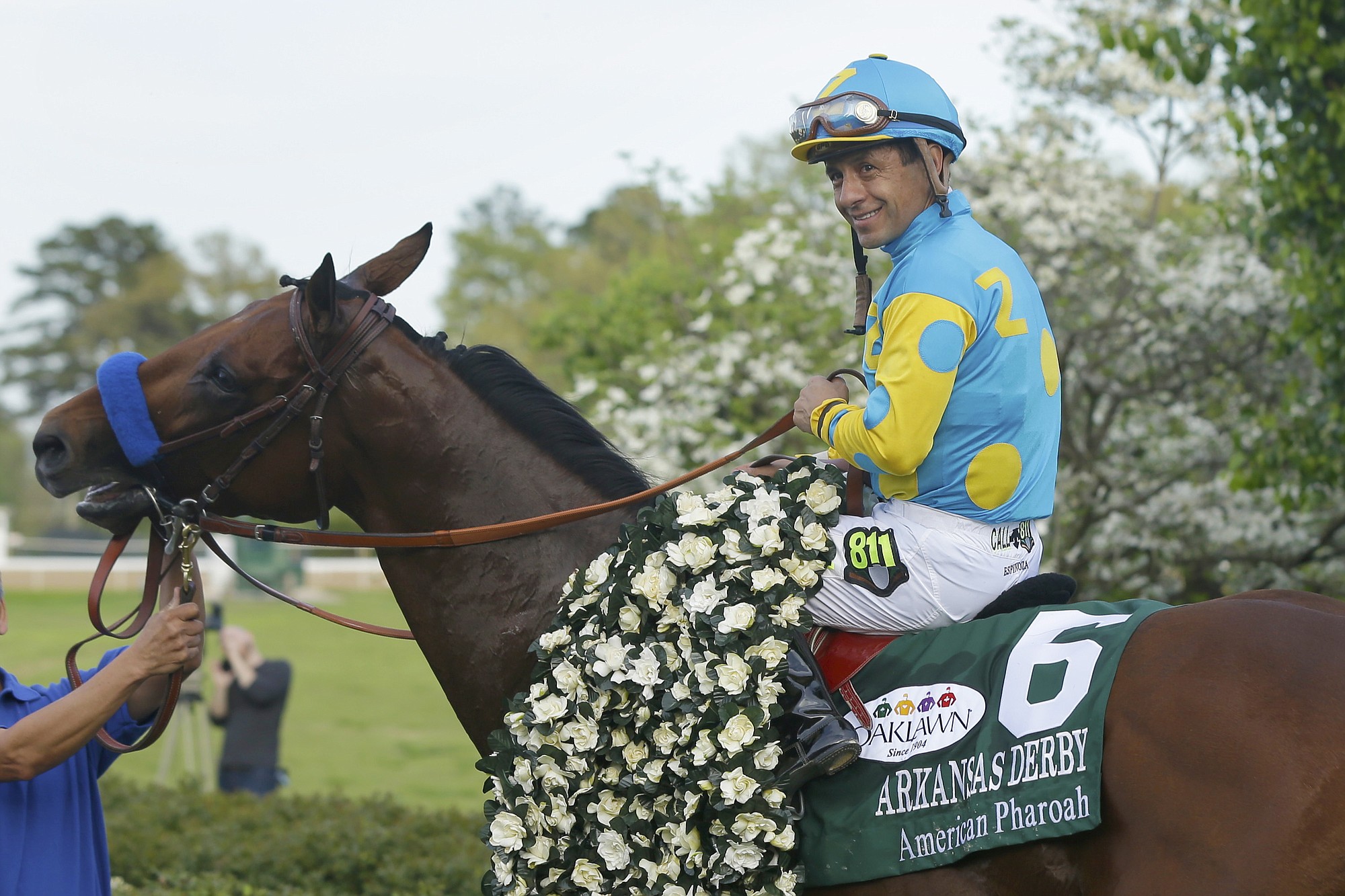 Jockey Victor Espinoza poses with American Pharoah in the winners circle after winning the $1 million Arkansas Derby in April.