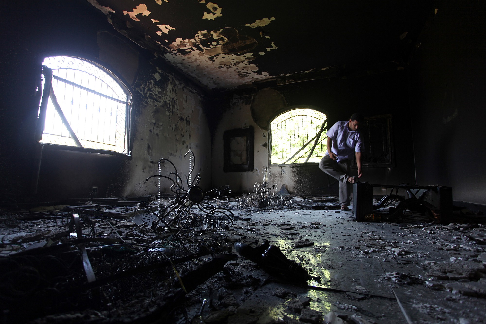 A Libyan man investigates the inside of the U.S. consulate in Benghazi, Libya, on Sept.