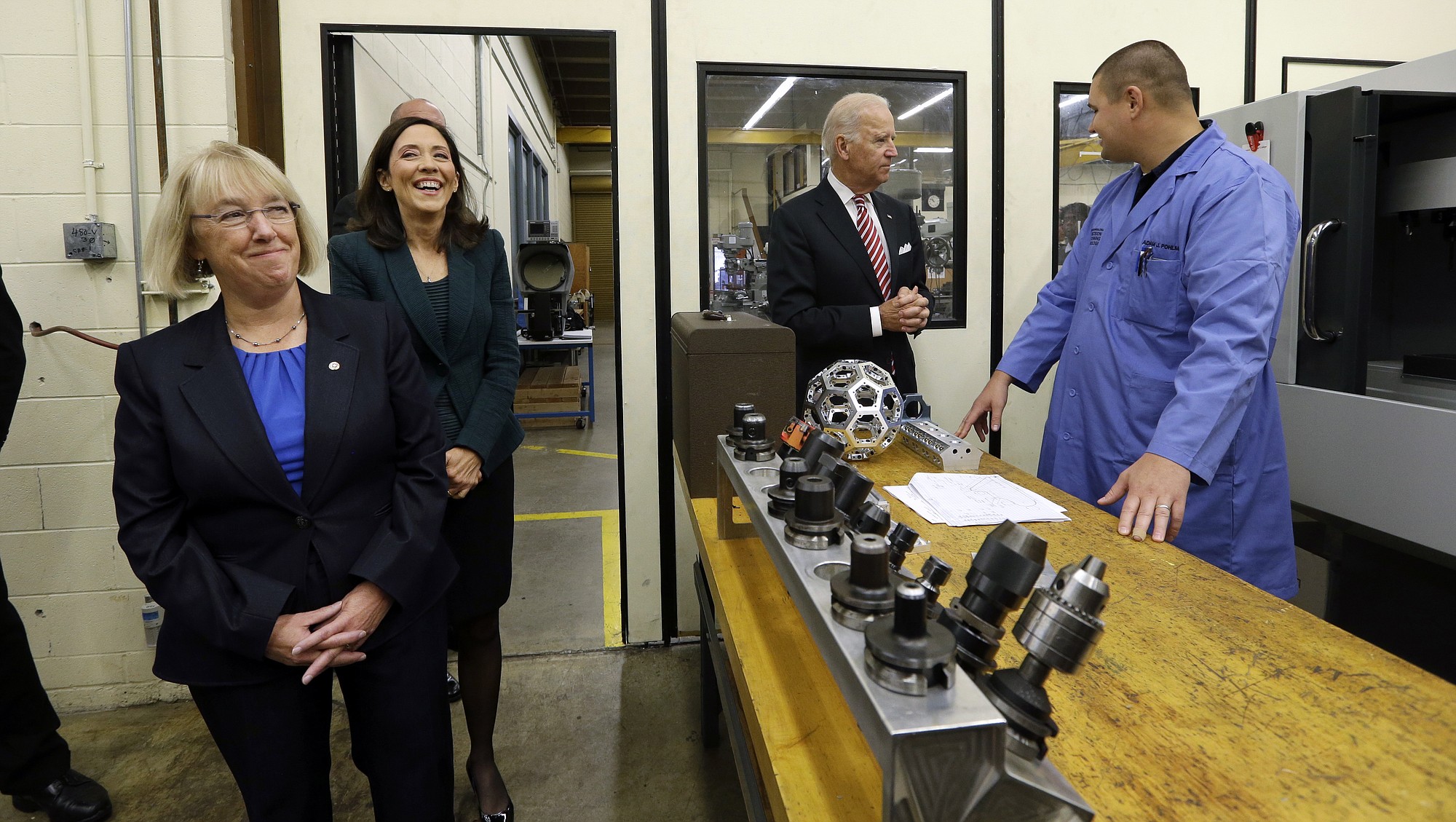 Sen. Patty Murray, D-Wash., left, and Sen. Maria Cantwell, D-Wash., second from left, walk into a shop as Vice President Joe Biden speaks with instructor Adam Pohlman at Renton Technical College in Renton, Wash., Thursday, Oct. 9, 2014. Biden discussed workplace and economic issues Thursday morning at the school and as part of a West Coast political swing, will also attend a luncheon in Seattle with Sen. Maria Cantwell.