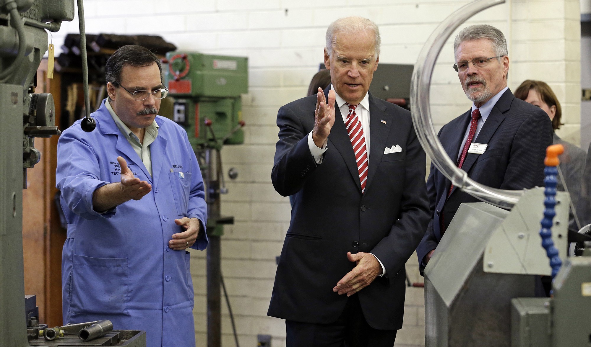 Vice President Joe Biden tours a machine shop with instructor Henry Hatem, left, and school president Steve Hanson at Renton Technical College in Renton, Wash., Thursday, Oct. 9, 2014. Biden discussed workplace and economic issues Thursday morning at the school and as part of a West Coast political swing, will also attend a luncheon in Seattle with Sen. Maria Cantwell.