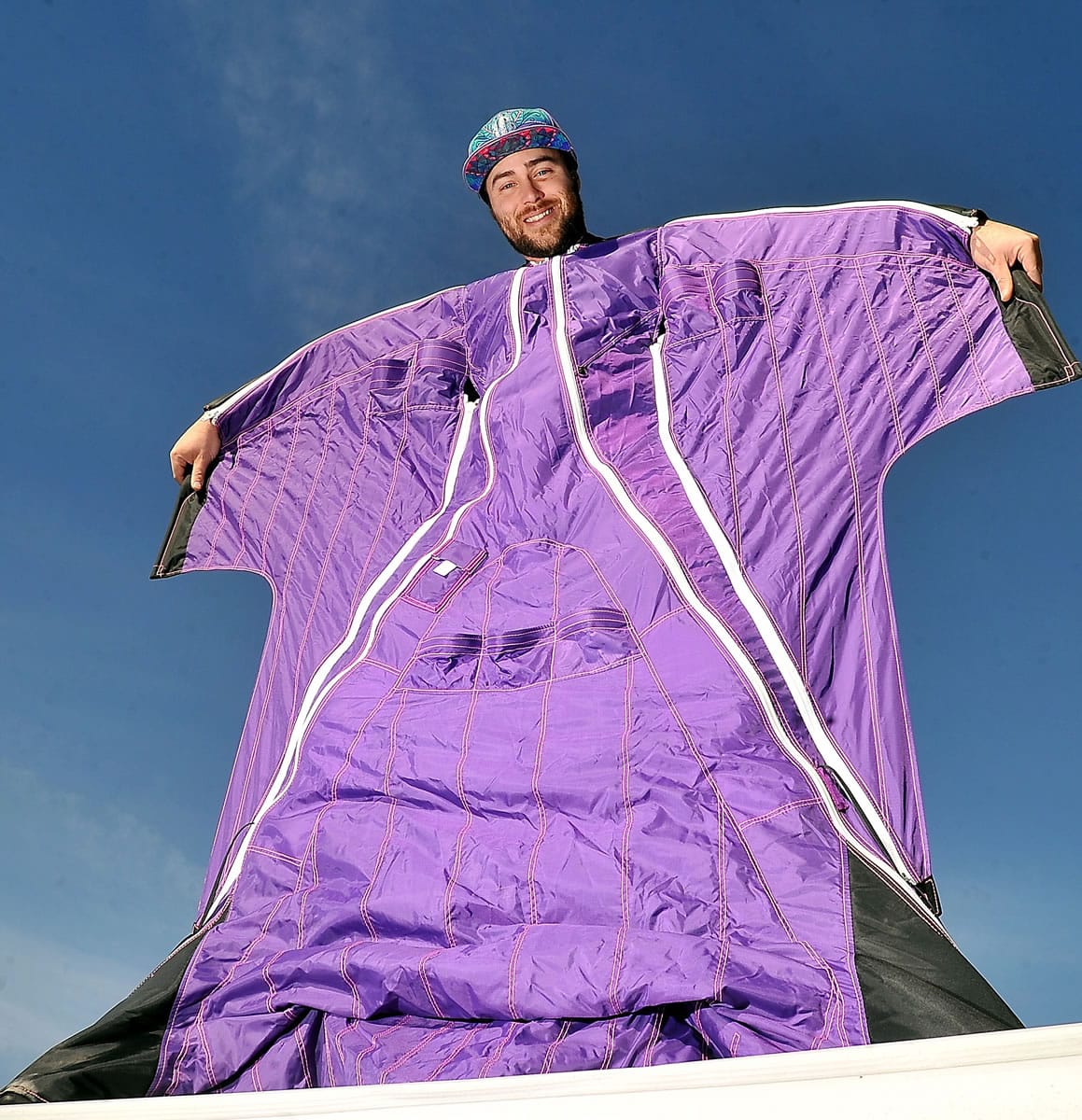 Blake Burwell, 31, shows off his wing suit Monday at his home in Talent, Ore.