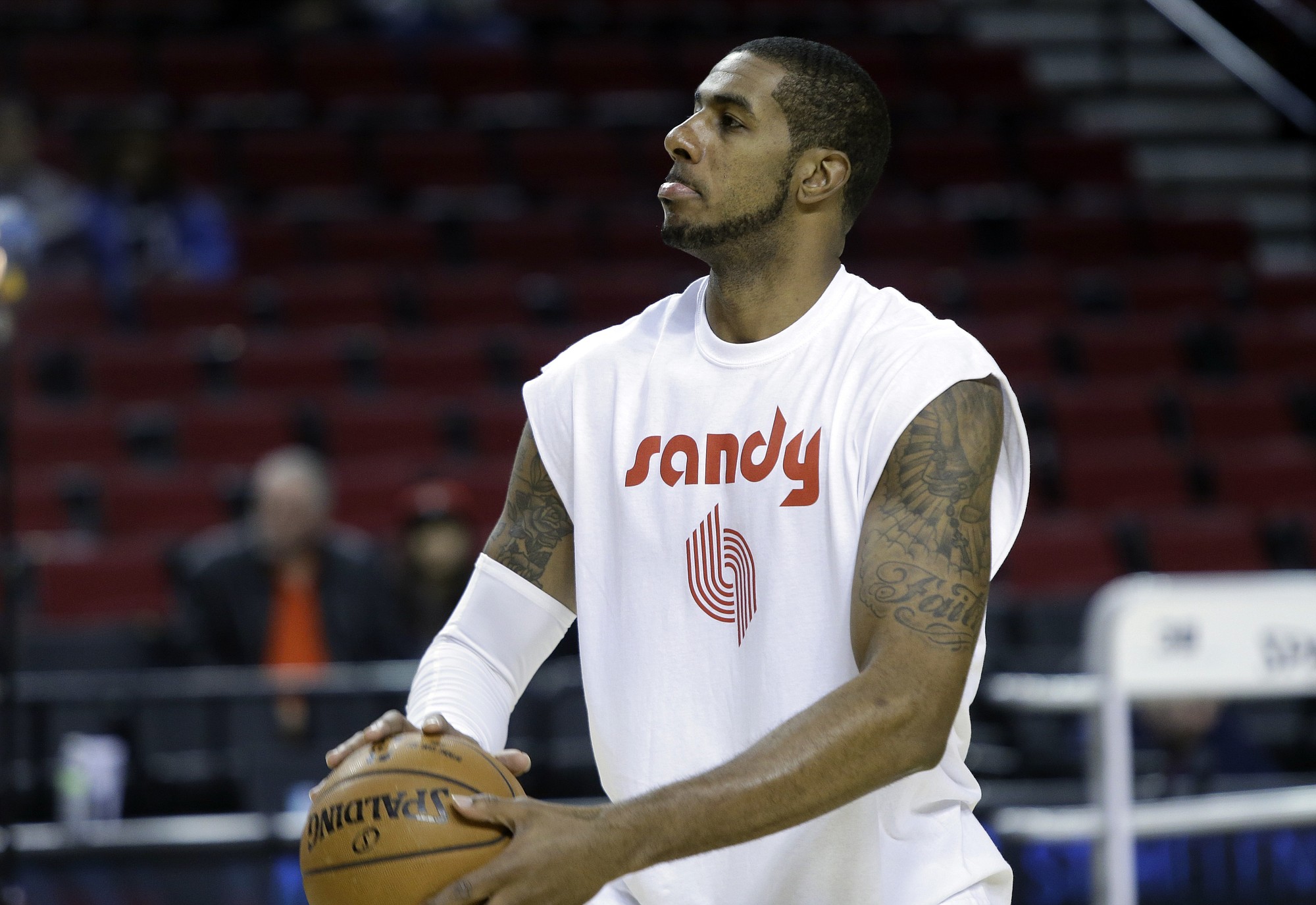 Portland Trail Blazers forward LaMarcus Aldridge wears a warmup shirt in memory of season ticket holder Sandra Zickefoose before their NBA basketball game against the Denver Nuggets in Portland, Ore., Sunday, Nov. 9, 2014. Zickefoose suffered a medical emergency during their game against Dallas Thursday night, was transported to a hospital and subsequently died.