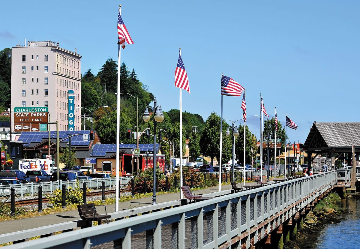American flags along the Coos Bay, Ore., Boardwalk fly in the breeze under sunny skies Wednesday.