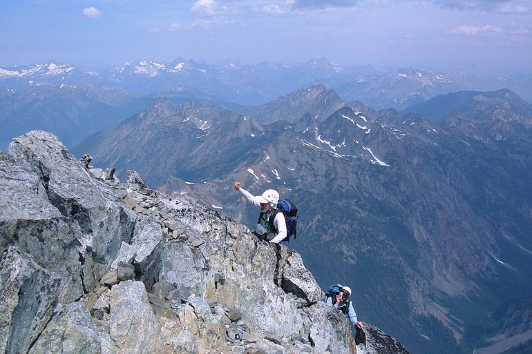 Bob Bolton raises his arms in celebration as he nears the top of Bonanza Peak, the highest point in Chelan County.