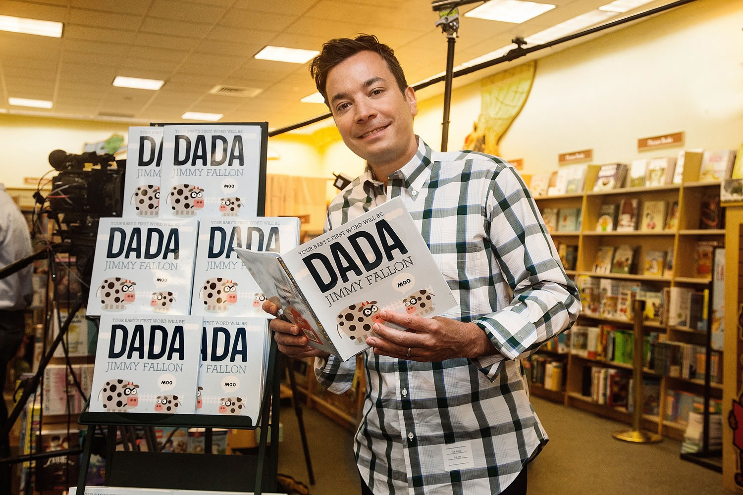 Late night talk show host Jimmy Fallon holds his new children's book, &quot;Your Baby's First Word Will Be Dada,&quot; at a bookstore  in New York.