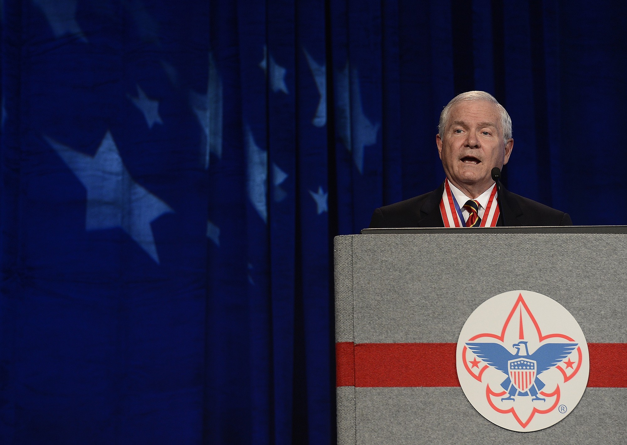 FILE - In this May 23, 2014, file photo, former Defense Secretary Robert Gates addresses the Boy Scouts of America's annual meeting in Nashville, Tenn., after being selected as the organization's new president. The executive committee of the Boy Scouts of America has unanimously approved a resolution that would end the organization's blanket ban on gay adult leaders and let individual scout units set their own policy on the long-divisive issue. The committee action follows an emphatic speech in May by the BSA's president, the former defense secretary declaring that the longstanding ban on participation by openly gay adults was no longer sustainable.