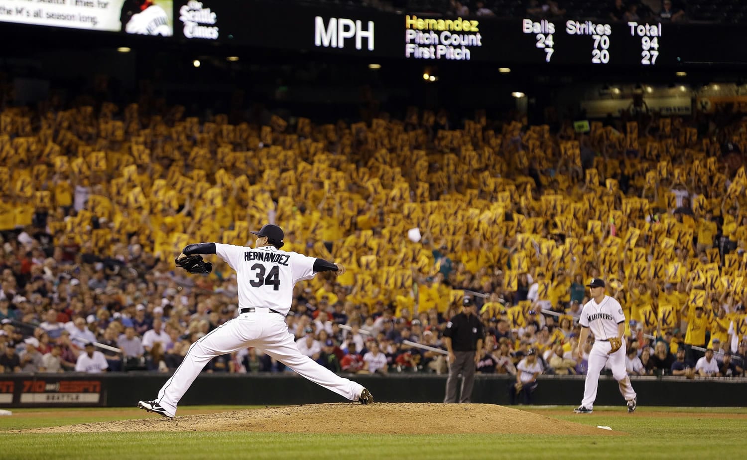 A sea of yellow &quot;K&quot; cards, designating a strikeout, are held in the stands behind Seattle Mariners staring pitcher Felix Hernandez as he throws against the Atlanta Braves in the eighth inning of a baseball game Tuesday, Aug. 5, 2014, in Seattle.