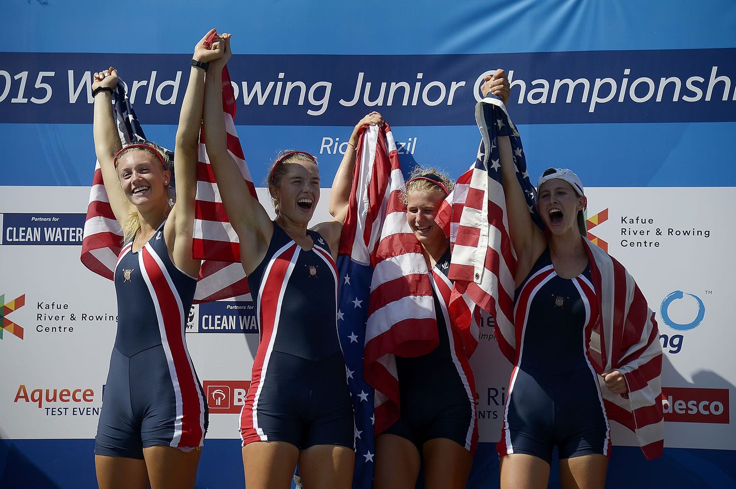 U.S. rowers, from left, Kaitlyn Kynast, Dana Moffat, Marlee Blue and Katy Gillingham celebrate winning the Junior Women's Four Final competition at the World Rowing Junior Championships at Rodrigo de Freitas lake in Rio de Janeiro, Brazil. American rowing officials are investigating why some rowers on their team came down with gastrointestinal illness at the contest, an event that concluded over the weekend and is being used as a trial run for next year's Rio de Janeiro Olympics.