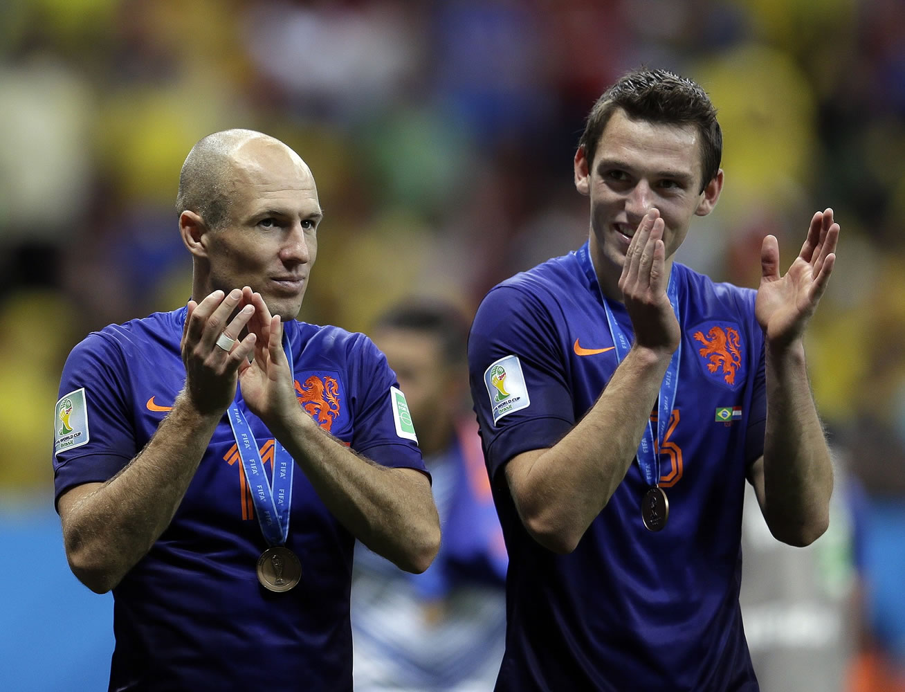 Netherlands' Arjen Robben, left and Stefan de Vrij applaud their supporters after their 3-0 victory over Brazil in the World Cup third-place match Saturday.