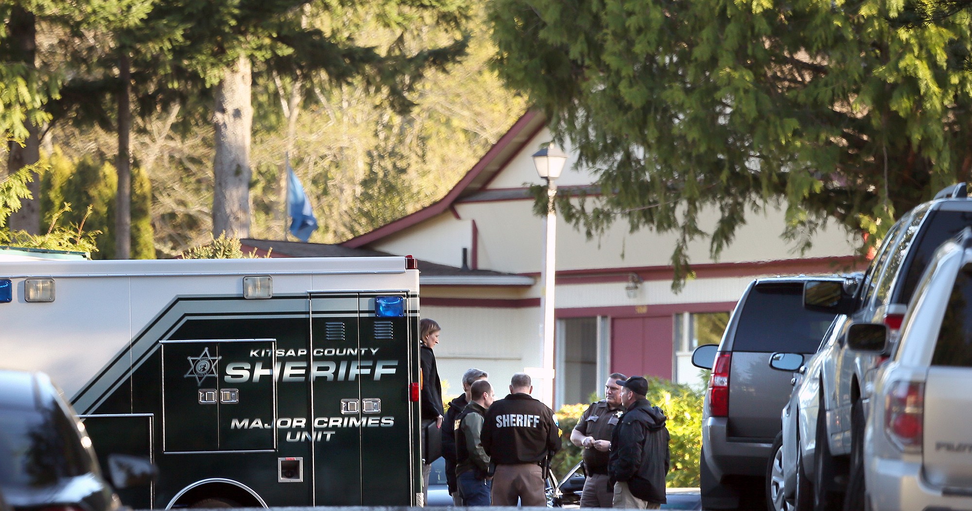 Kitsap County Sheriff's deputies and detectives gather to investigate the early Saturday morning shooting of three people in East Bremerton.