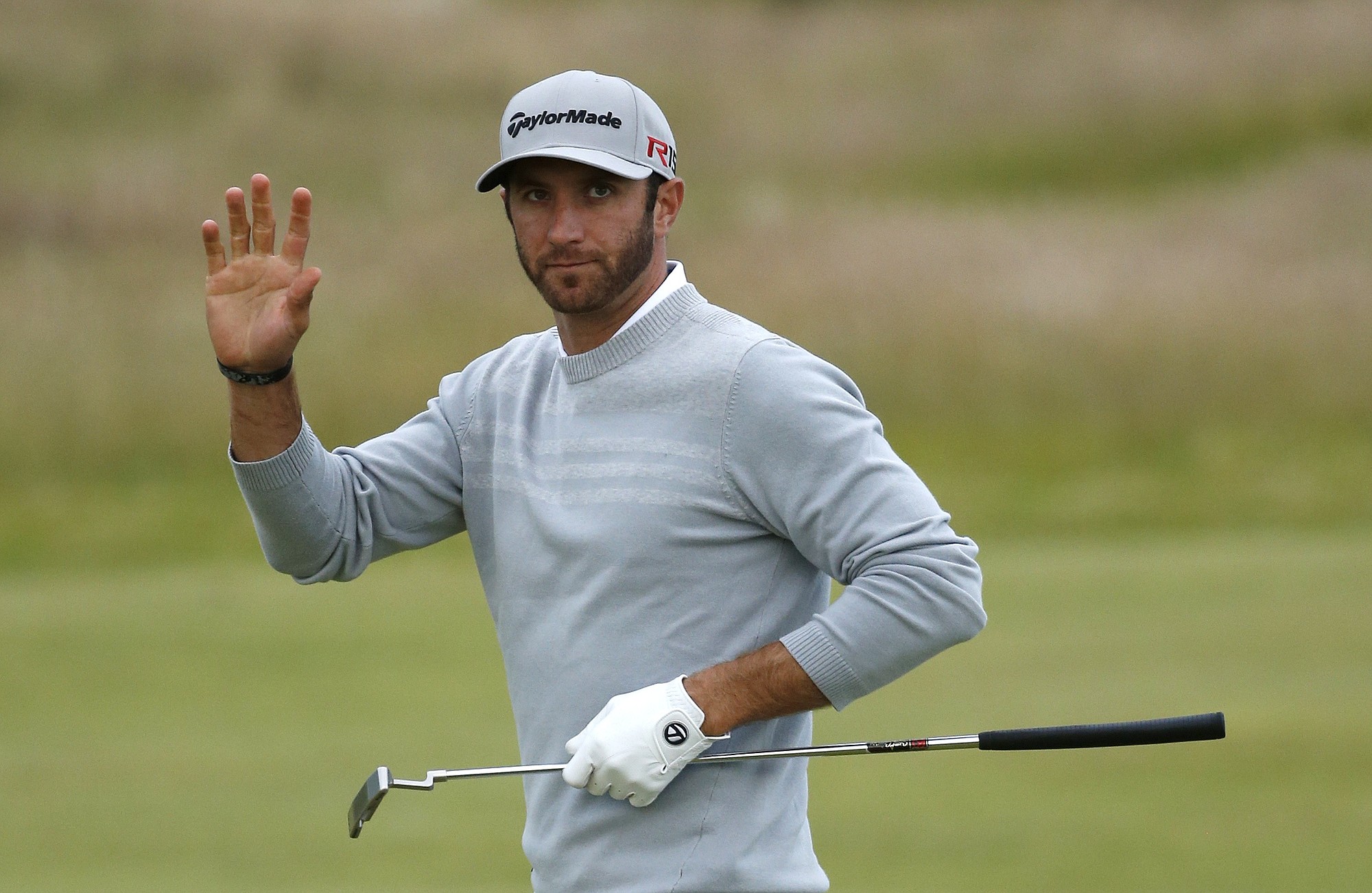 United States? Dustin Johnson waves after making a putt on the 10th green during the second round of the British Open Golf Championship at the Old Course, St. Andrews, Scotland, Friday, July 17, 2015.
