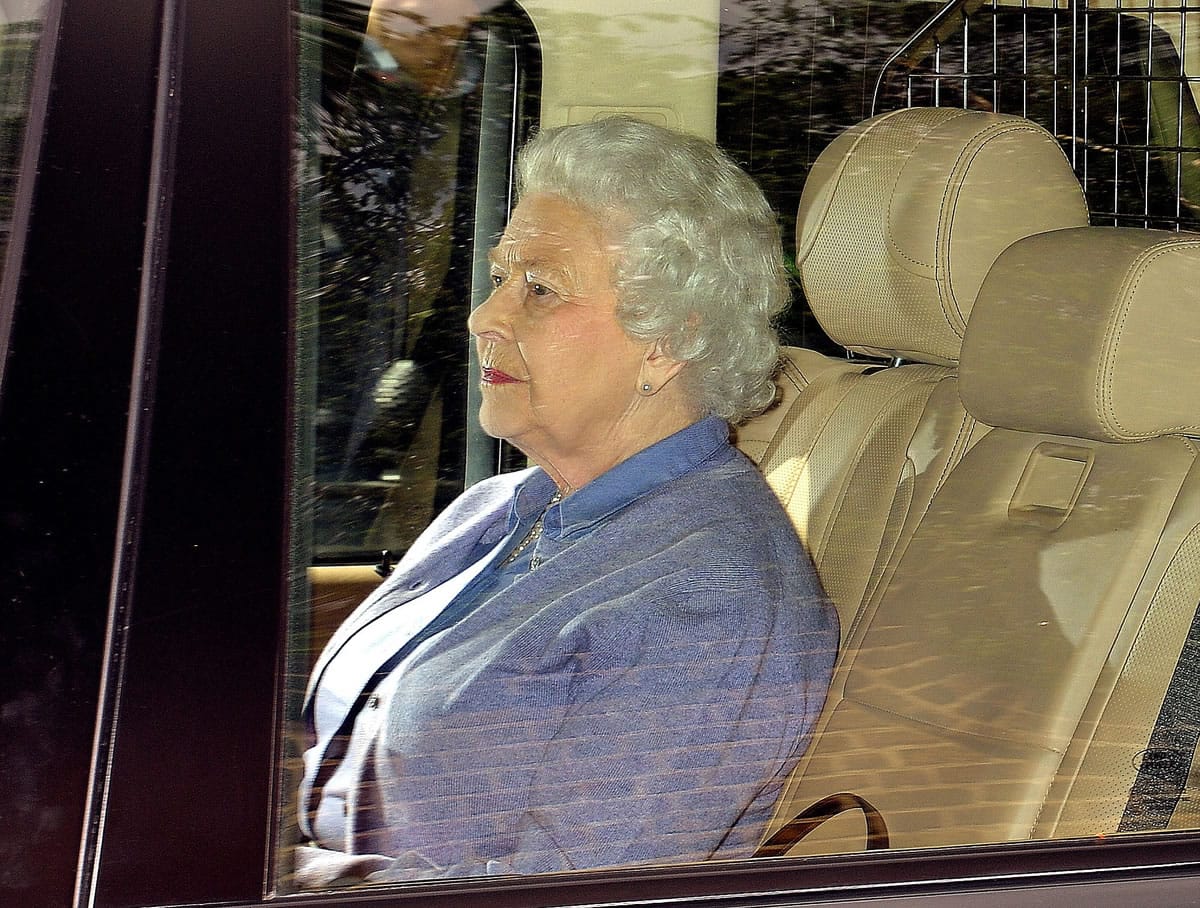 Britain's Queen Elizabeth II sits in the back seat of her vehicle Tuesday as she leaves Kensington Palace, in London, after meeting her great granddaughter Princess Charlotte of Cambridge who was born on Saturday at St Mary's Hospital in Paddington west London.