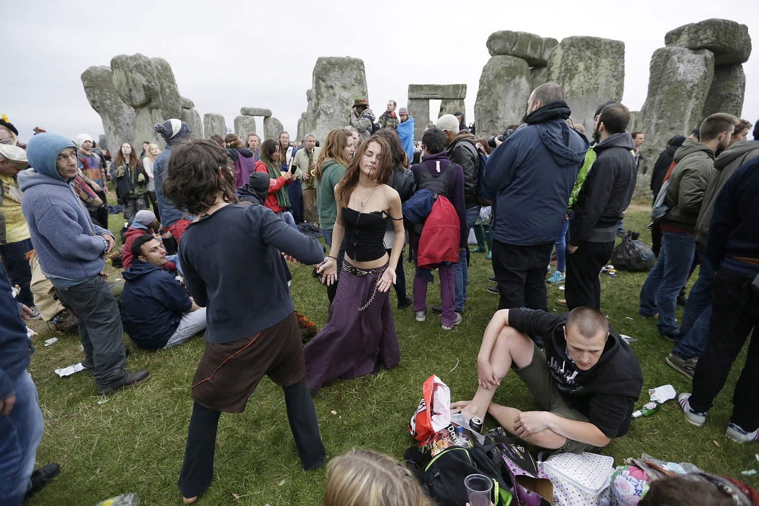 People dance as thousands of revelers gathered Sunday at the ancient stone circle Stonehenge to celebrate the summer solstice, the longest day of the year, near Salisbury, England.