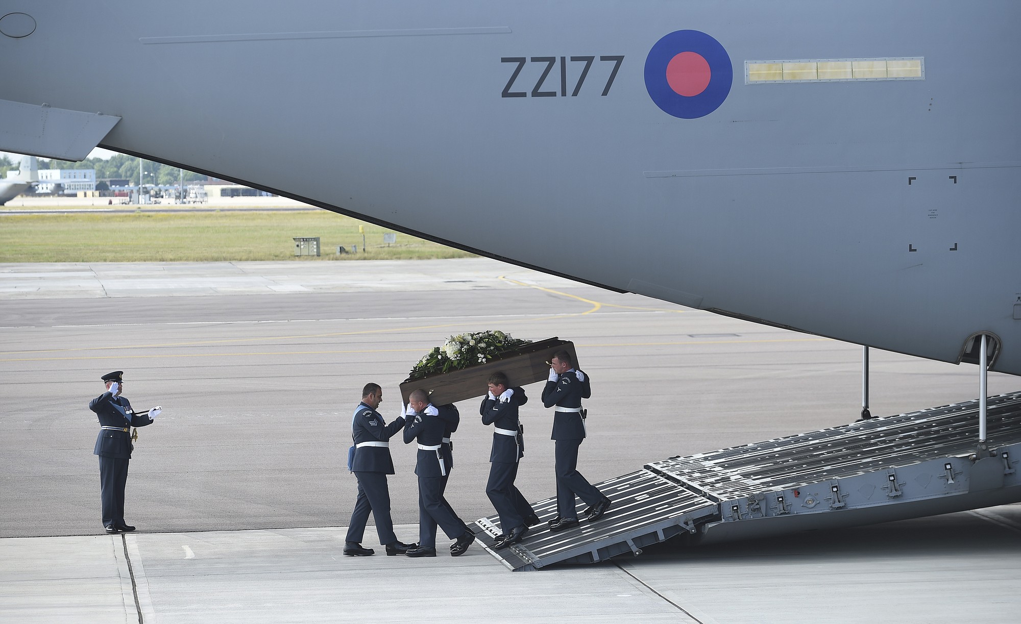 A coffin is carried from a British RAF C-17 plane, confirmed as carrying the body of Adrian Evans, as the bodies of eight British nationals killed Friday in the Tunisia beach terror attack at RAF Brize Norton, England, on Wednesday.