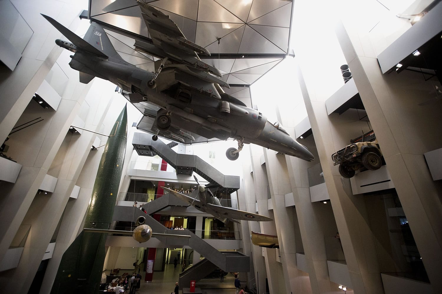 Military exhibits are displayed in the newly transformed atrium after major redevelopment works at the Imperial War Museum in London, Wednesday, July 16, 2014.  The museum reopens Saturday after a six-month closure for a 40 million pound ($70 million) renovation timed to mark the centenary of World War I.  The museum was founded in 1917, as the war still raged, to preserve the stories of those who were fighting and dying. It retains that goal, as well its archaic name, relic of a long-gone British Empire.