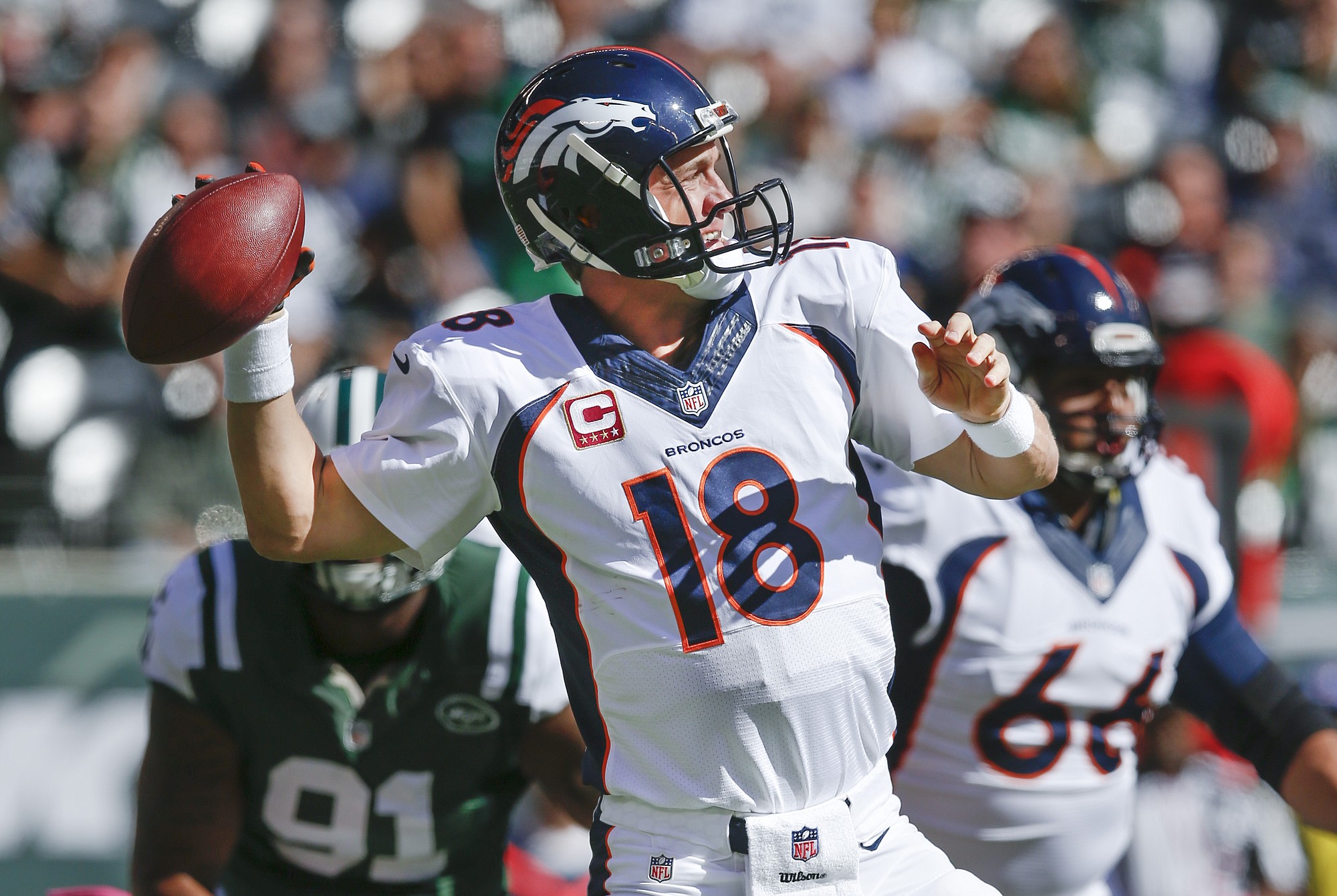 Denver Broncos quarterback Peyton Manning (18) throws against the New York Jets in the first quarter Sunday, Oct. 12, 2014, in East Rutherford, N.J.