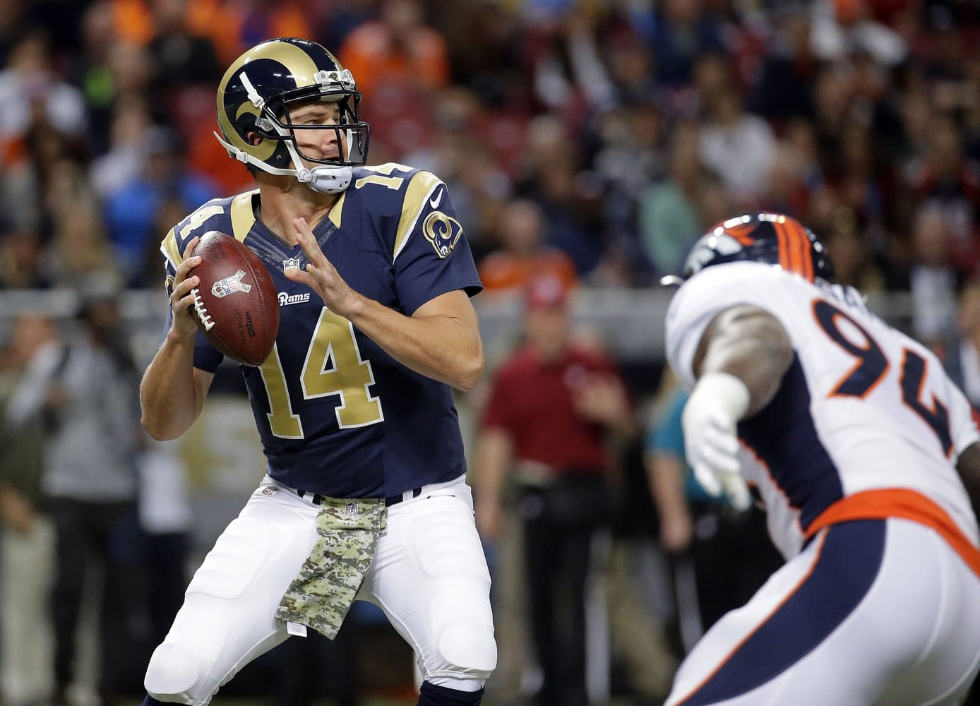 St. Louis Rams quarterback Shaun Hill, left, throws under pressure from Denver Broncos defensive end DeMarcus Ware during the first quarter Sunday, Nov. 16, 2014, in St. Louis.
