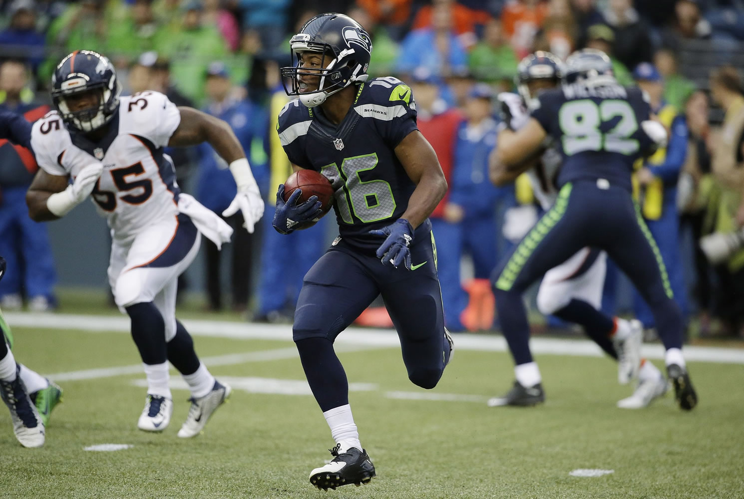 Seattle Seahawks' Tyler Lockett returns a kickoff 103 yards for a touchdown against the Denver Broncos during the second quarter of a preseason NFL football game, Friday, Aug.