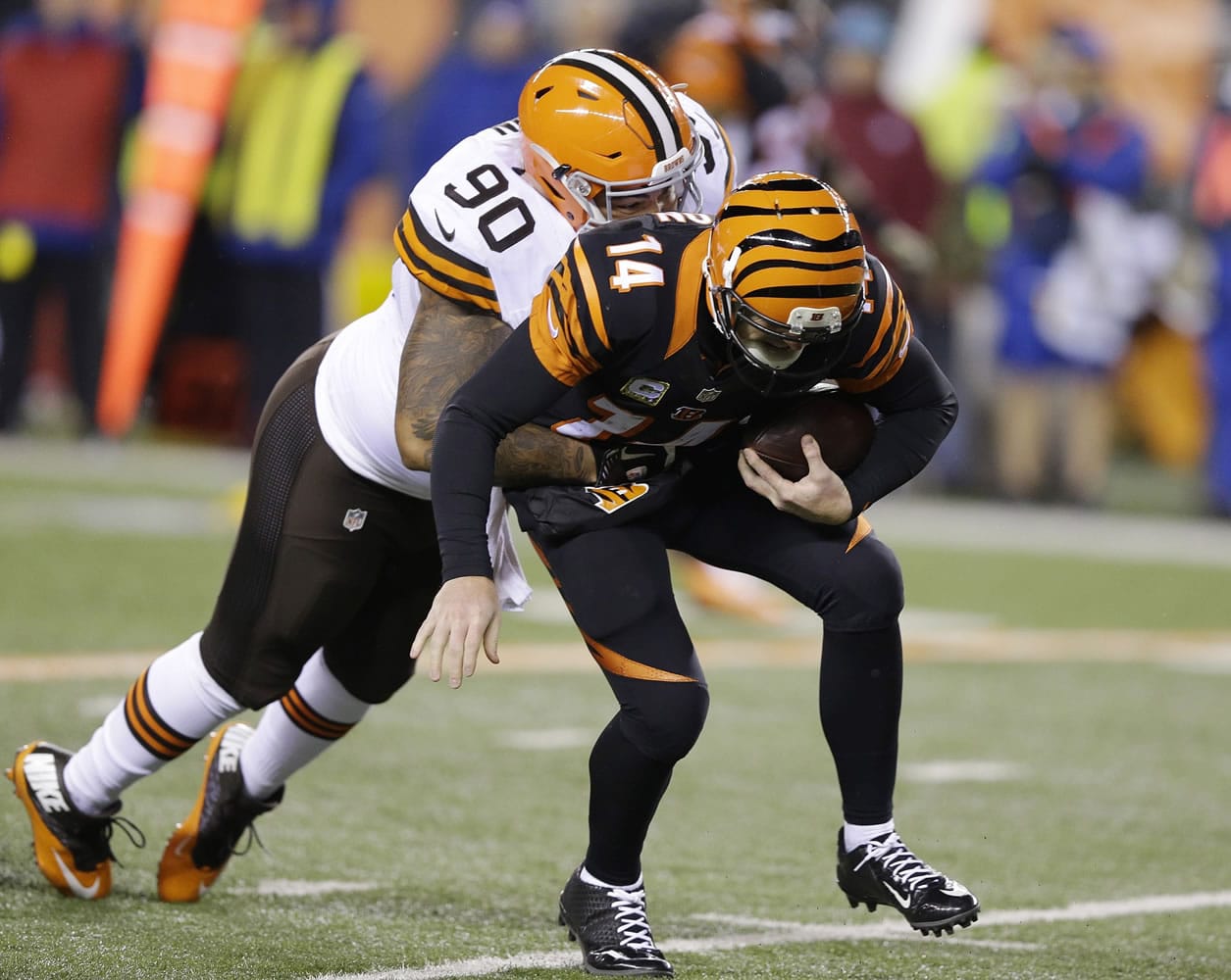 Cleveland Browns defensive end Billy Winn (90) sacks Cincinnati Bengals quarterback Andy Dalton during the second half of an NFL football game Thursday, Nov. 6, 2014, in Cincinnati.