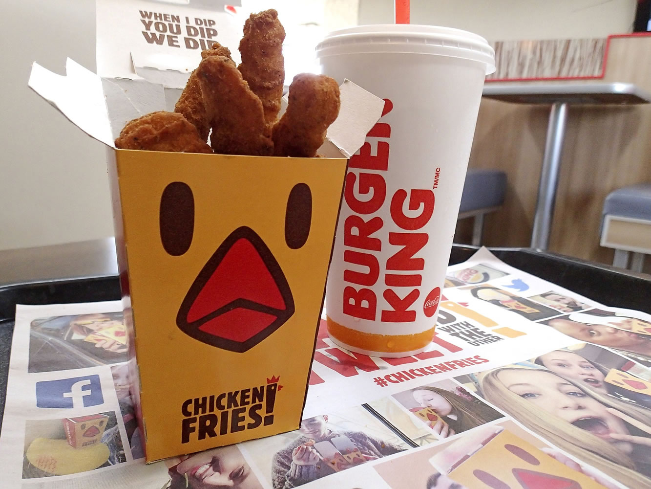 Chicken fries and a soft drink are posed for a photo at a Burger King restaurant