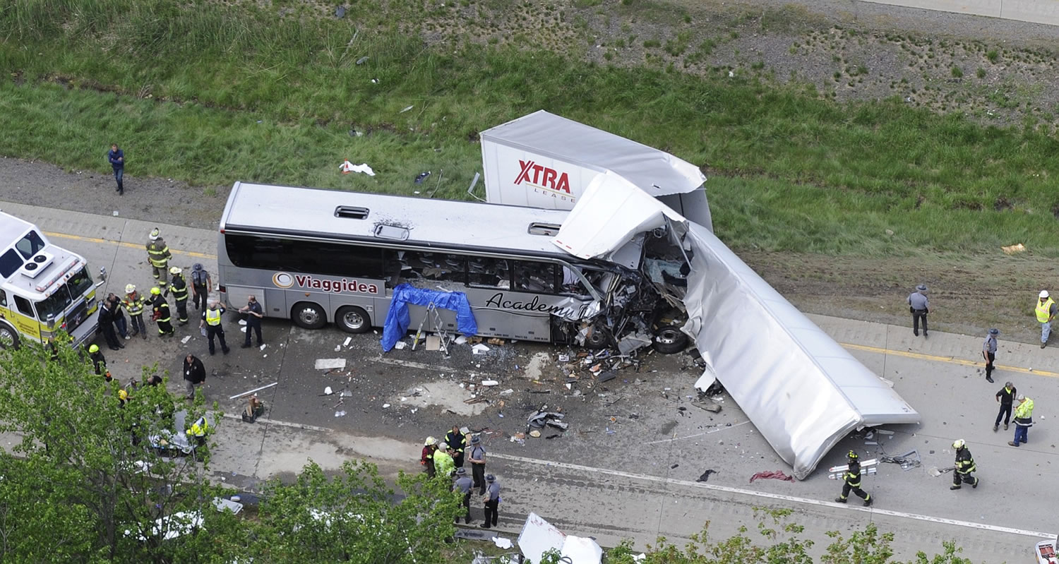 Authorities investigate the scene of a fatal collision between a tractor-trailer and a tour bus on Interstate 380 near Mount Pocono, Pa., Wednesday.