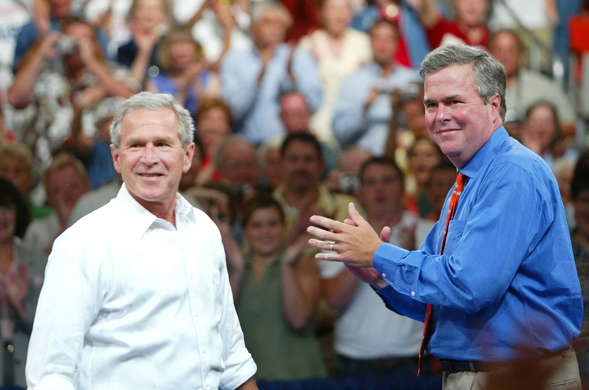Former President George Bush, left, says younger brother Jeb Bush, the former Florida governor, is probably a 50-50 bet to run for president in 2016.