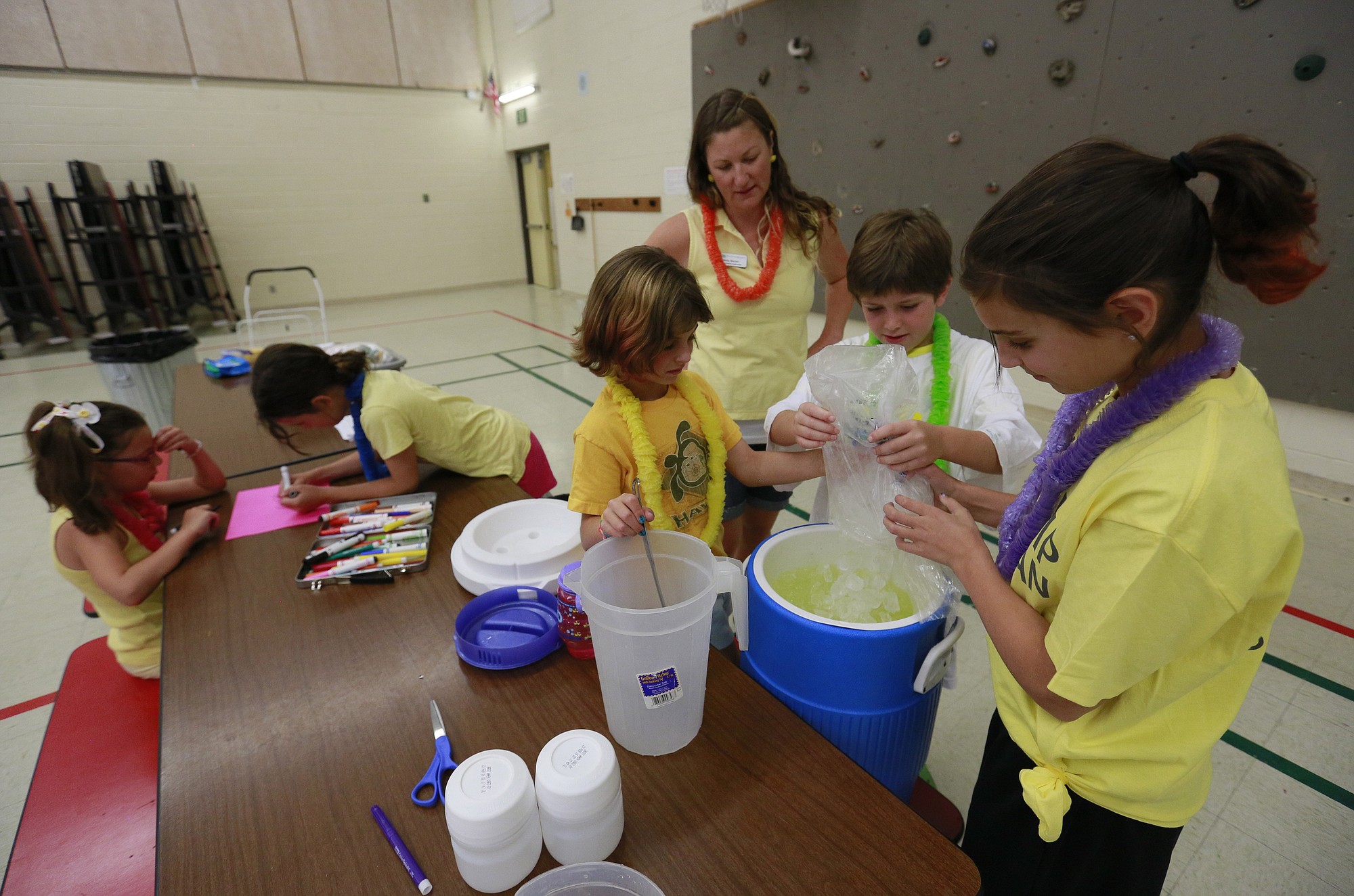 Kids in the Bend Parks and Recreation Department's &quot;Summer Lemonade Stand camp&quot; prepare lemonade for sale at Cascade Middle School in Bend, Ore.
