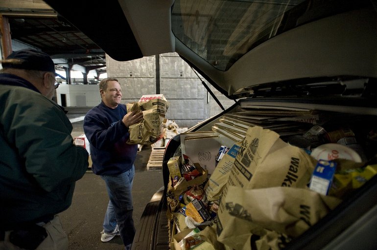 Food continued to come in Sunday and Jeff Fish, left, and Dave Rawson were there to unload it at a warehouse near the Port of Vancouver.