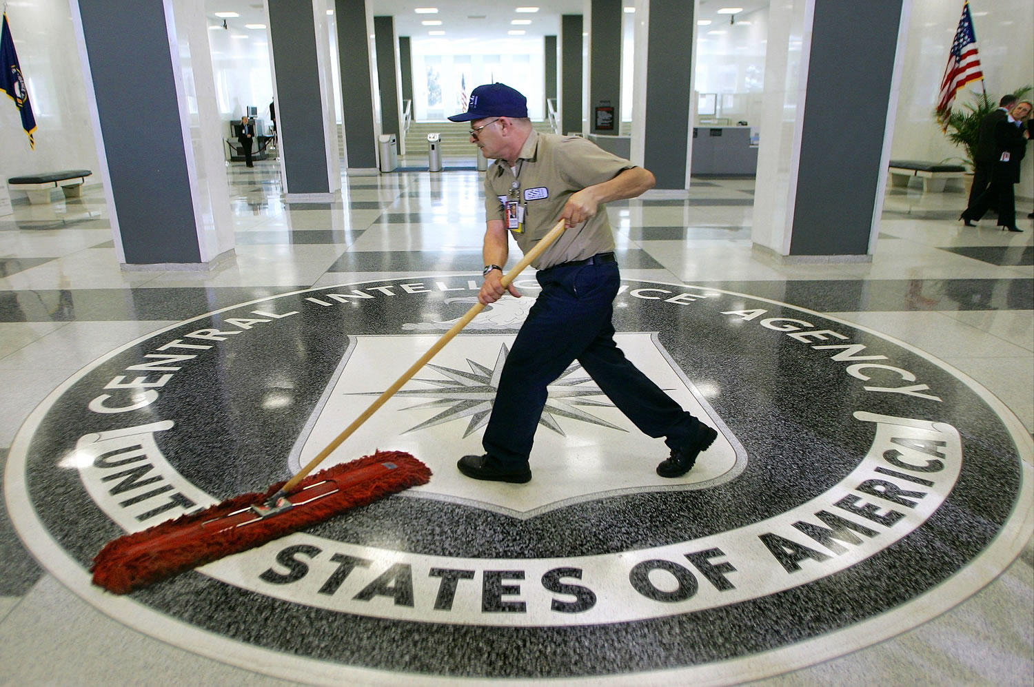 A workman slides a dustmop over the floor at the Central Intelligence Agency headquarters in Langley, Va.