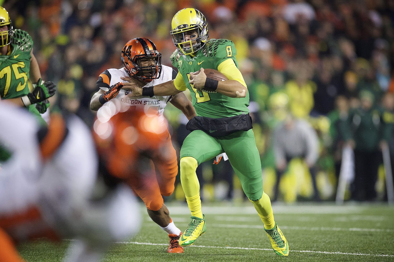 Oregon quarterback Marcus Mariota (8) breaks away from Oregon State defender Jabral Johnson (44) for a touchdown during the second quarter Saturday in Corvallis, Ore.