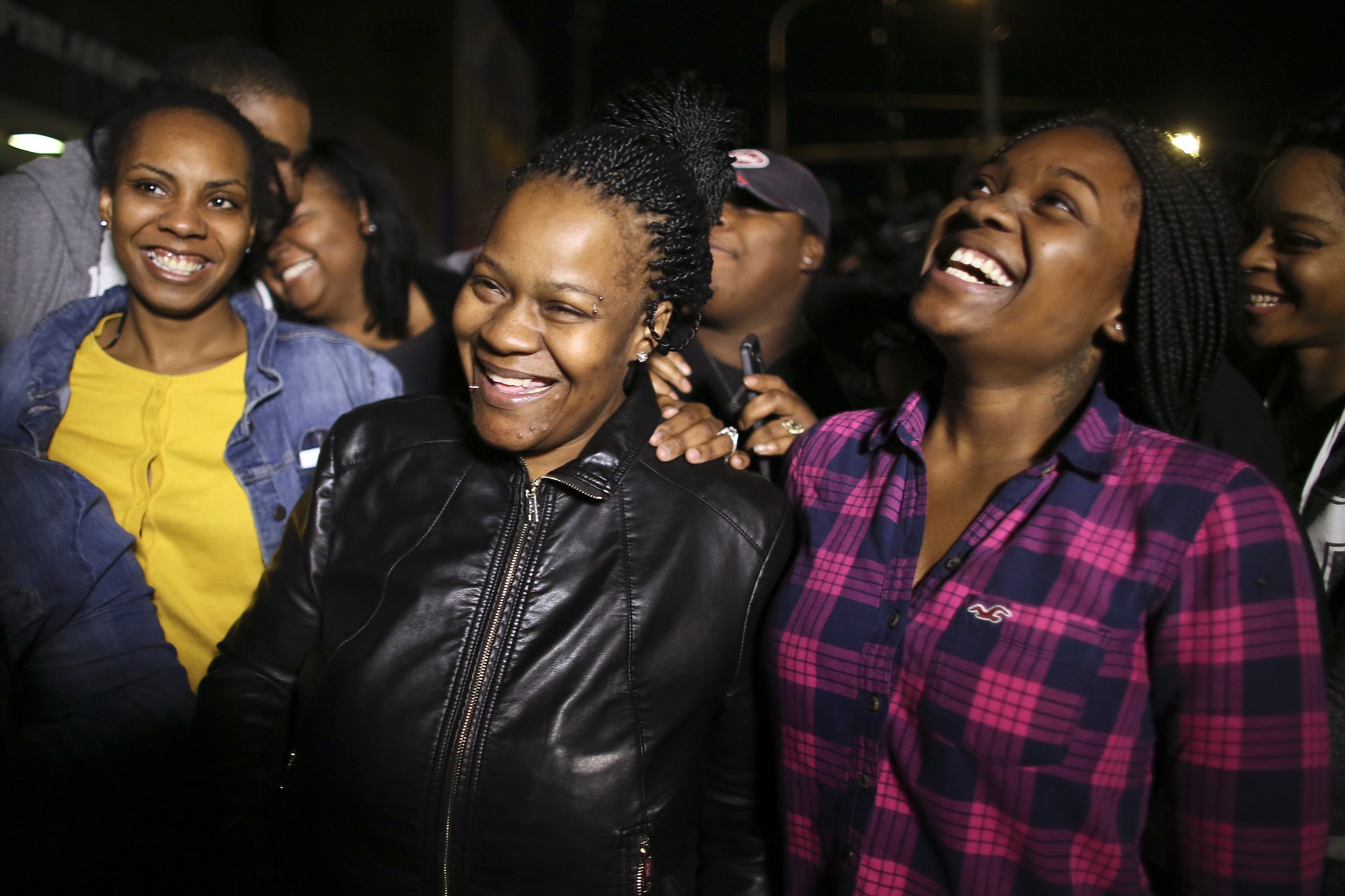 Family members surround Keisha Gaither, second from left, mother of kidnapping victim Carlesha Freeland-Gaither, as they celebrate Wednesday following a news conference in Philadelphia.