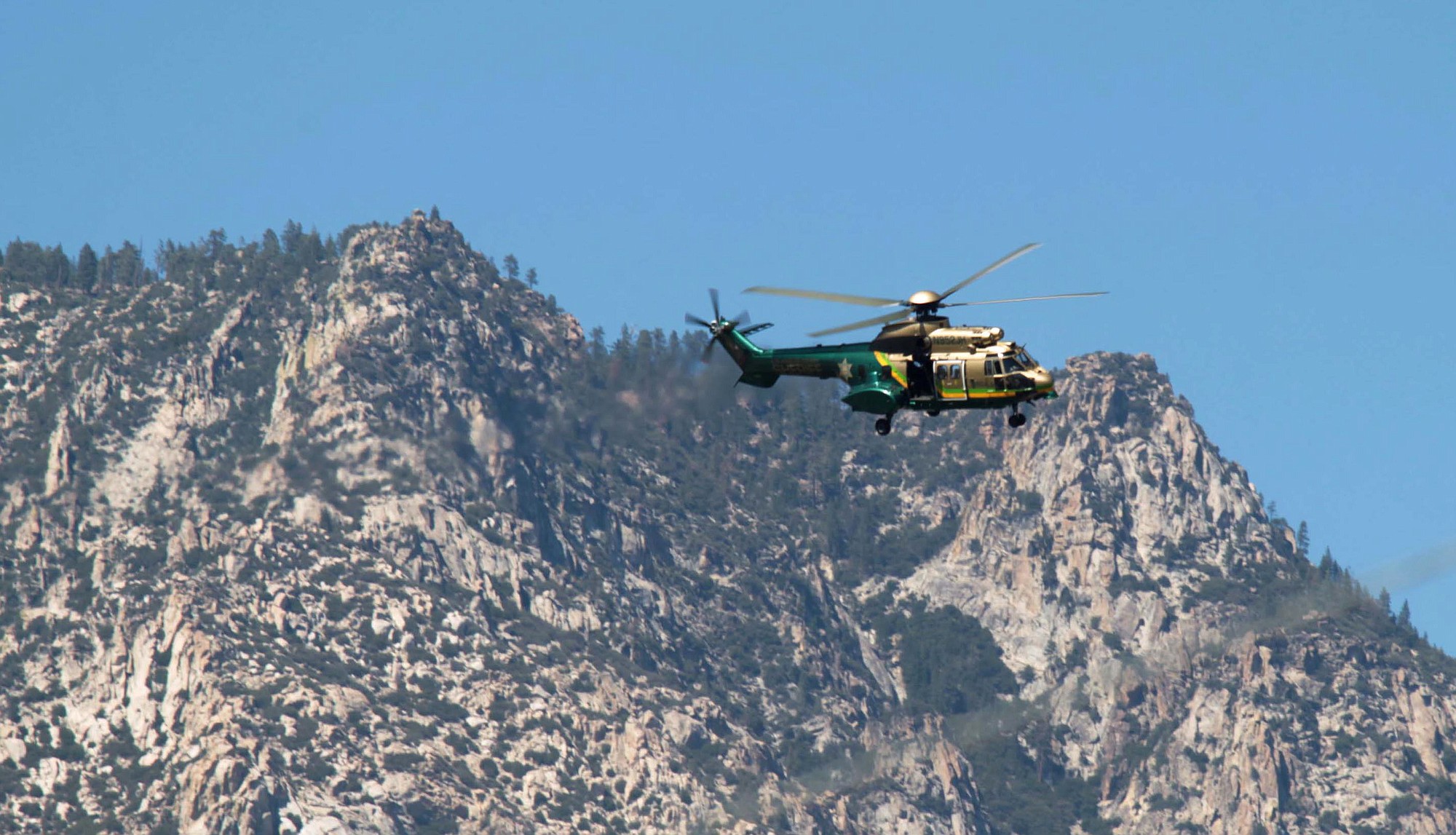 A Los Angeles County Sheriff's helicopter flies near Weldon, Calif.