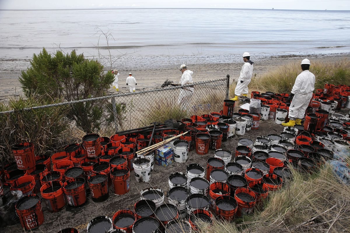 Plastic buckets with oil collected from the beach are placed Thursday at Refugio State Beach, north of Goleta, Calif. More than 7,700 gallons of oil has been raked, skimmed and vacuumed from a spill that stretched across 9 miles of California coast, just a fraction of the sticky, stinking goo that escaped from a broken pipeline, officials said. (AP Photo/Jae C.
