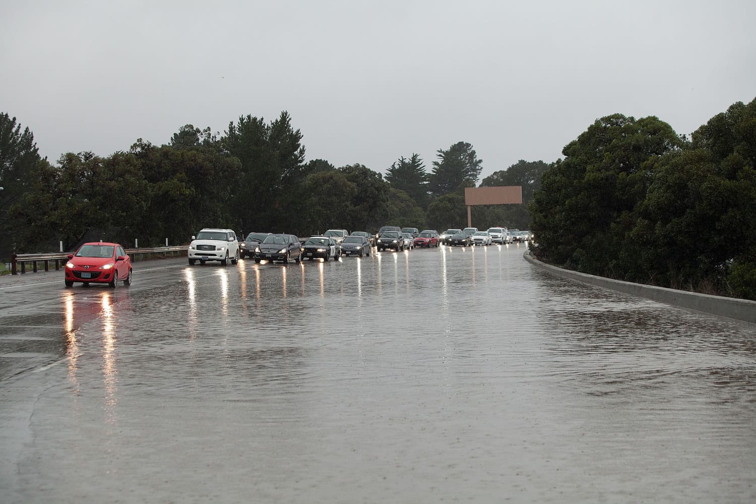 Cars make their way past flooding as they head south on the 280 freeway through Daly City, Calif. on Thursday, Dec. 11, 2014, as a powerful storm churned through the San Francisco Bay Area on Thursday, knocking out power to tens of thousands and delaying commuters while bringing a soaking of much needed rain.